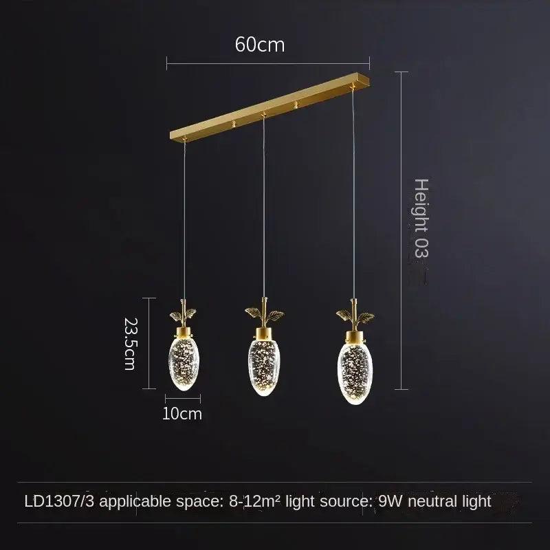 Gold-toned decorbites crystal chandelier with three pineapple-shaped glass globes and LED lights for modern luxury lighting