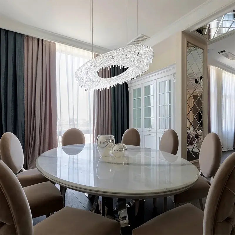 A decorbites crystal chandelier with sleek modern design and dazzling crystals hangs above a dining table