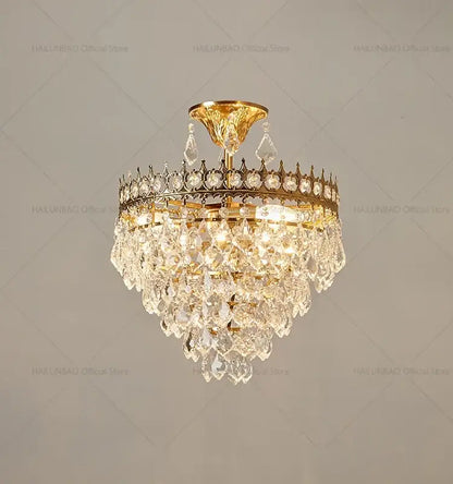 Decorbites crystal chandelier gold-toned with cascading crystal droplets and decorative crown frame for luxury lighting