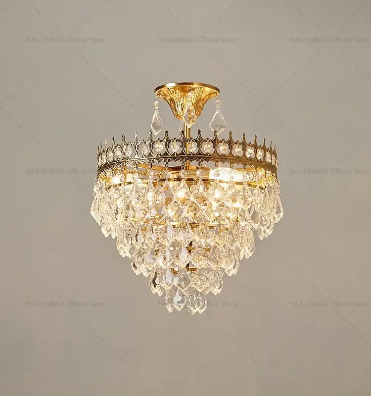 Decorbites crystal chandelier gold-toned with cascading crystal droplets and decorative crown frame for luxury lighting