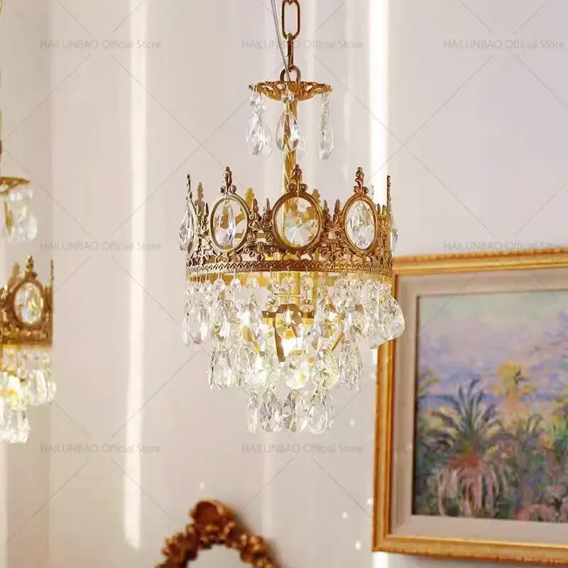 Golden crown-shaped decorbites crystal chandelier with clear crystal droplets and oval-cut crystals for luxury lighting