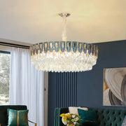 A decorbites crystal chandelier with metallic frame blue and gold accents and cascading clear crystals for modern luxury lighting