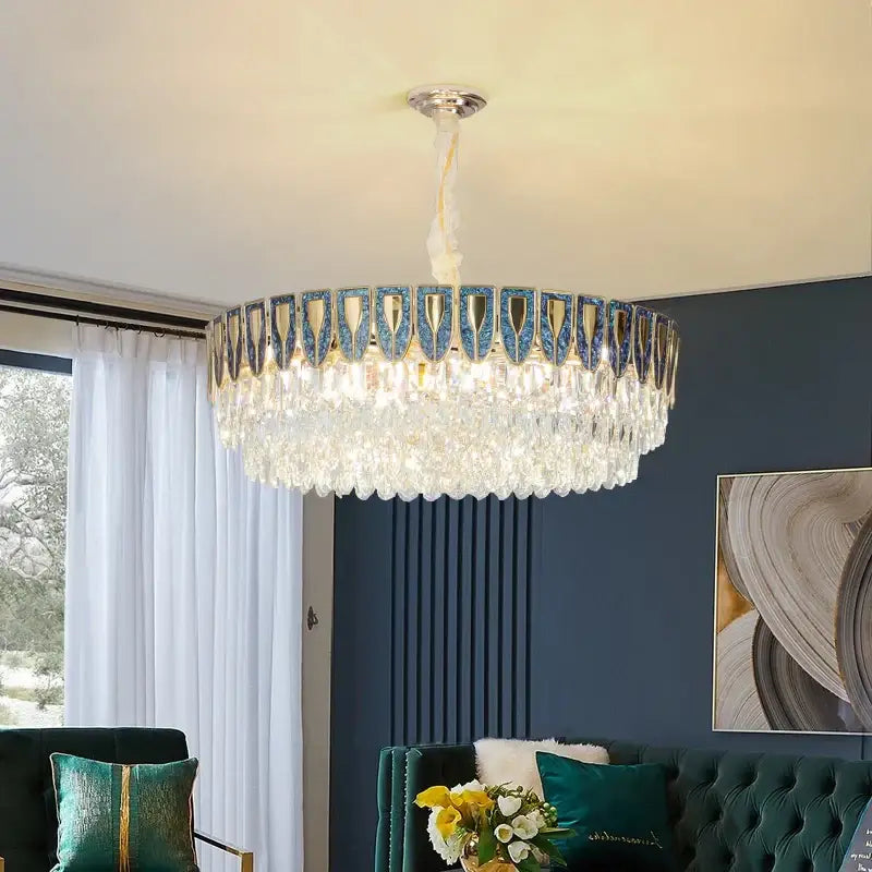 A decorbites crystal chandelier with metallic frame blue and gold accents and cascading clear crystals for modern luxury lighting