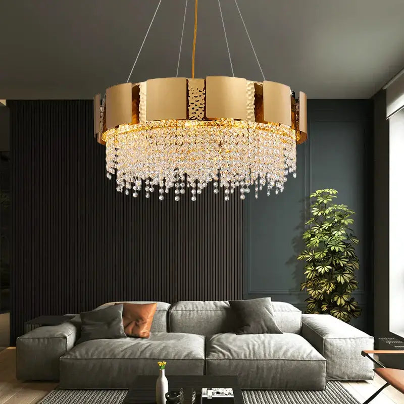 Gold-toned DecorBites crystal chandelier with circular frame and cascading crystal droplets for modern luxury lighting