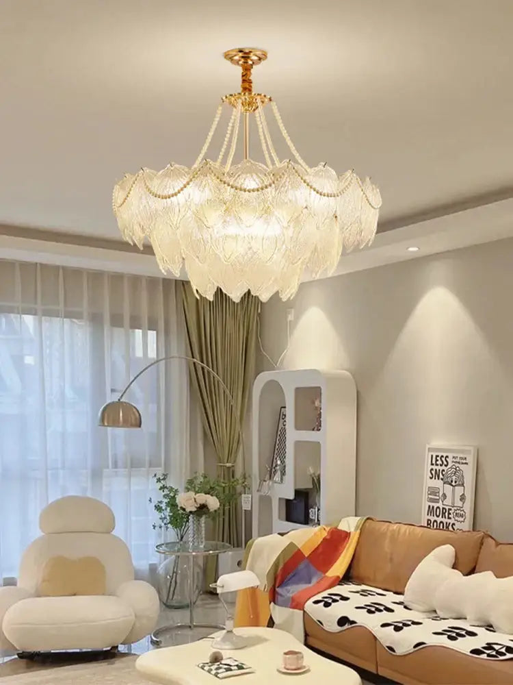 A golden-toned decorbites crystal chandelier with layered petal-shaped glass shades for modern luxury lighting
