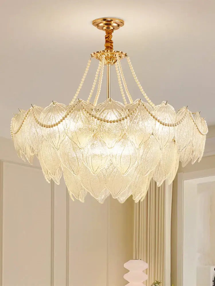 Elegant gold-toned decorbites crystal chandelier with layered translucent glass leaf shades and delicate beaded chains for luxury lighting