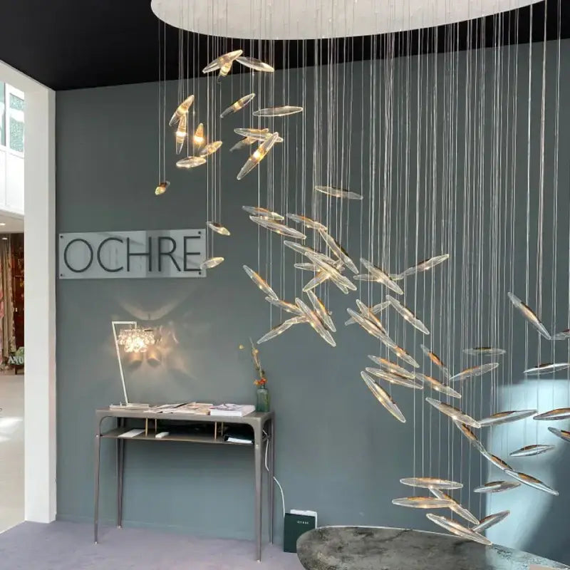 Decorbites crystal chandelier featuring translucent glass fish-shaped elements in a flowing modern design for luxury spaces