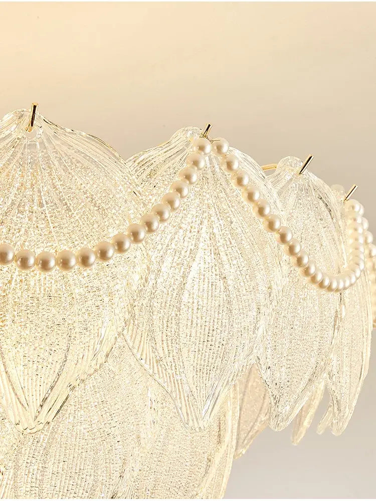 A decorbites crystal chandelier with translucent glass leaves and cream pearls for modern luxury lighting