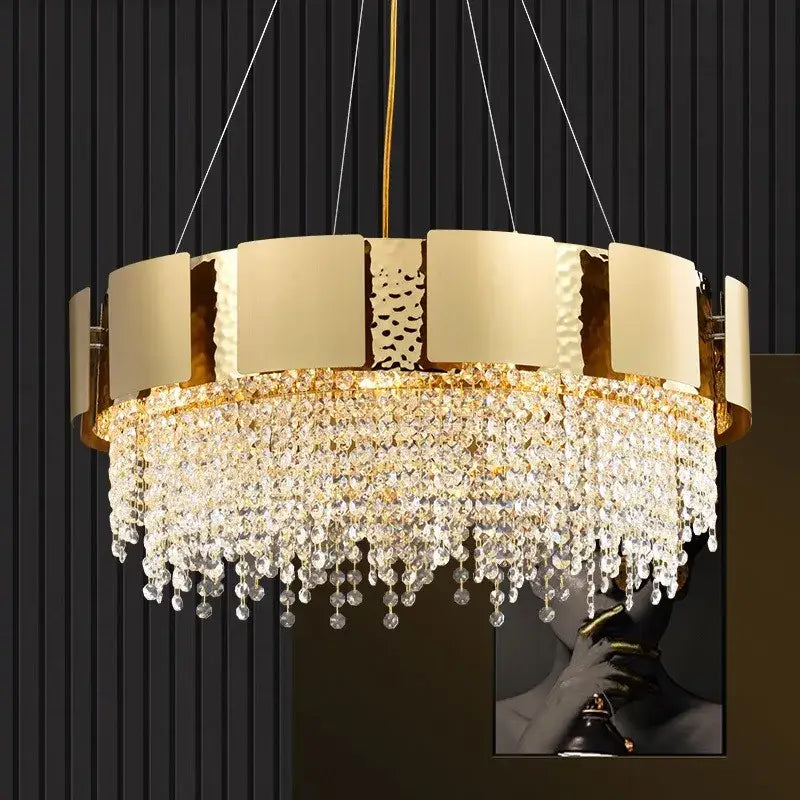 Gold-toned DecorBites crystal chandelier with circular textured panels and cascading clear crystal droplets for luxury lighting
