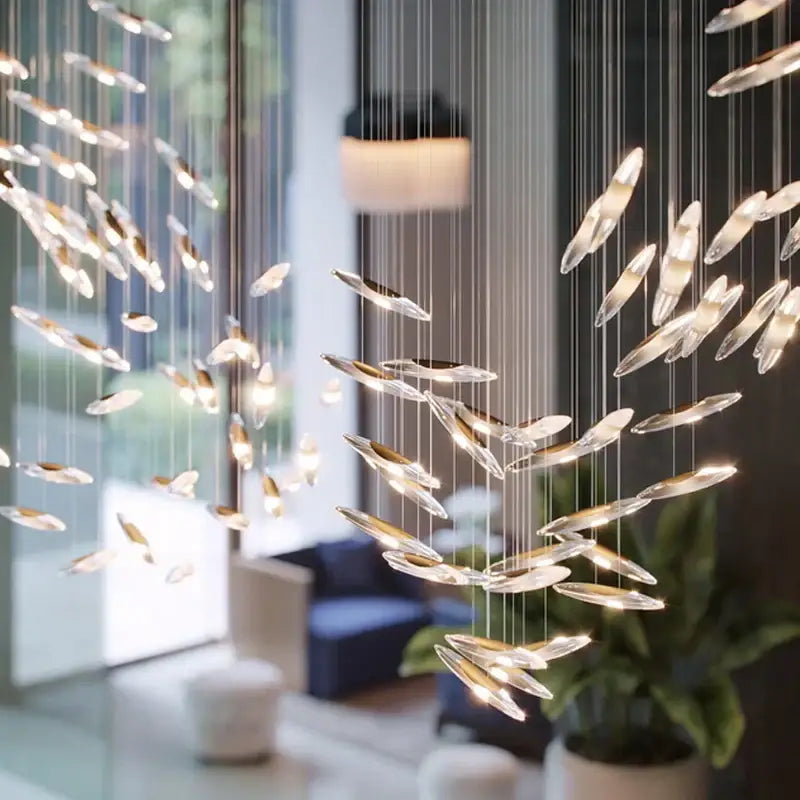 Modern decorbites crystal chandelier with translucent fish-shaped glass and gold accents for luxury living spaces