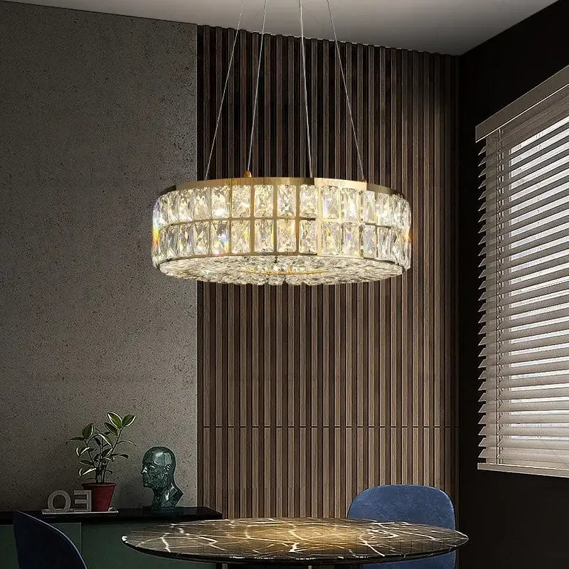 A modern decorbites crystal chandelier with gold metal frame and clear crystal prisms for luxury living spaces