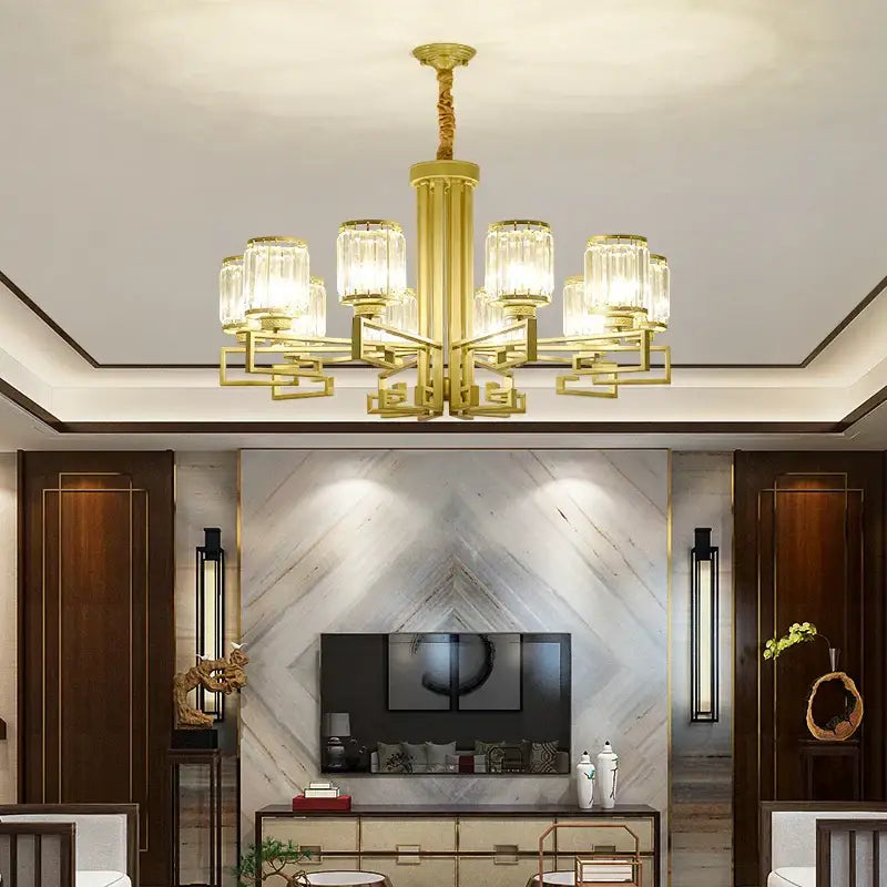 Gold-toned decorbites crystal chandelier with clear glass shades and geometric metal arms for modern luxury lighting