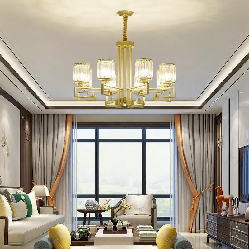 Gold-toned decorbites crystal chandelier with five crystal-encased lights and modern geometric design for elegant spaces