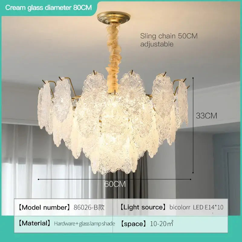 A delicate cream glass decorbites crystal chandelier with lace-like patterns and brass hardware for modern luxury spaces