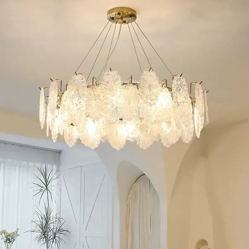 Elegant gold-toned decorbites crystal chandelier with translucent frosted glass petals for modern luxury living rooms
