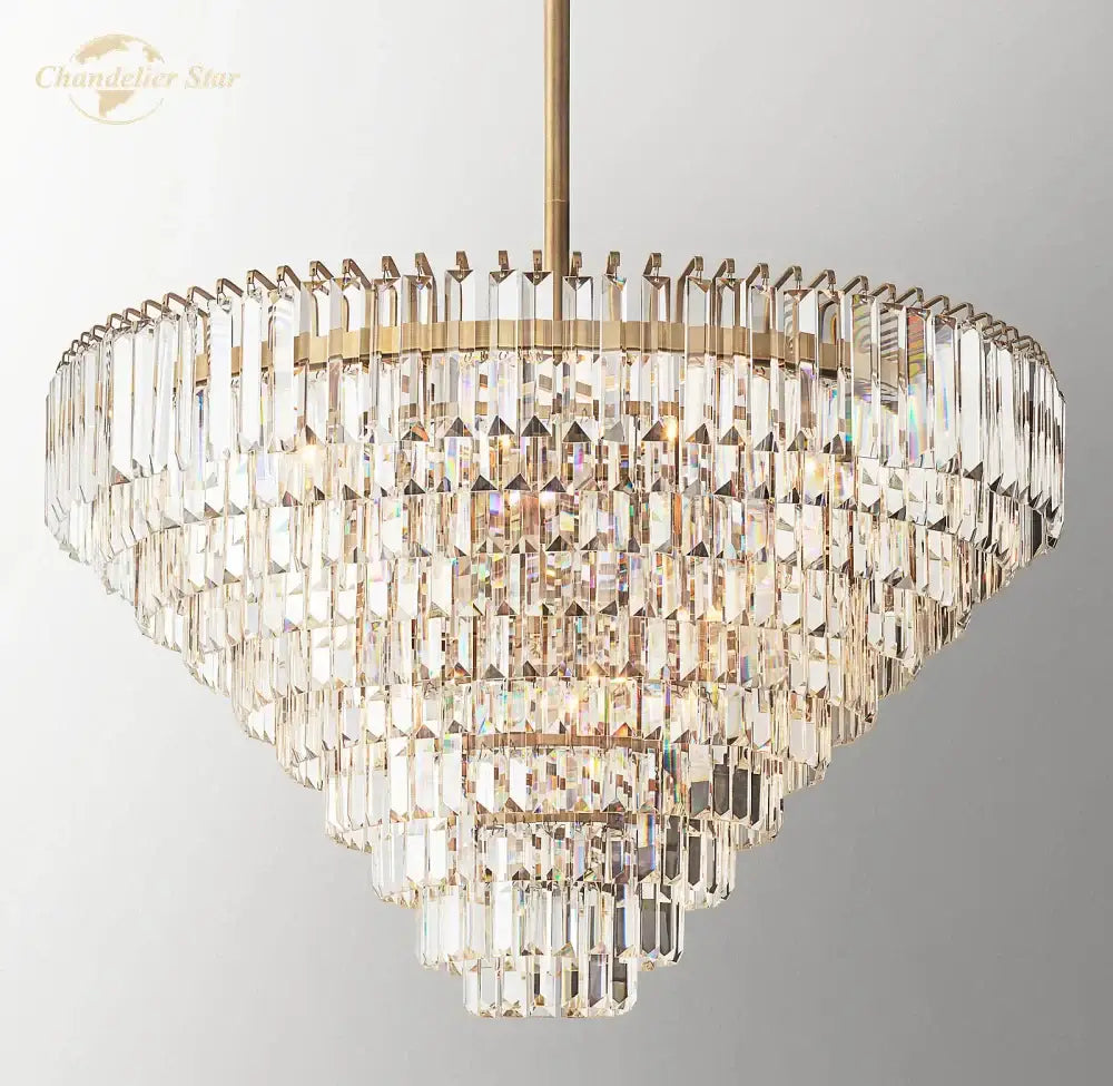 Decorbites crystal chandelier featuring a multi-tiered brass finish with cascading faceted clear crystals refracting light