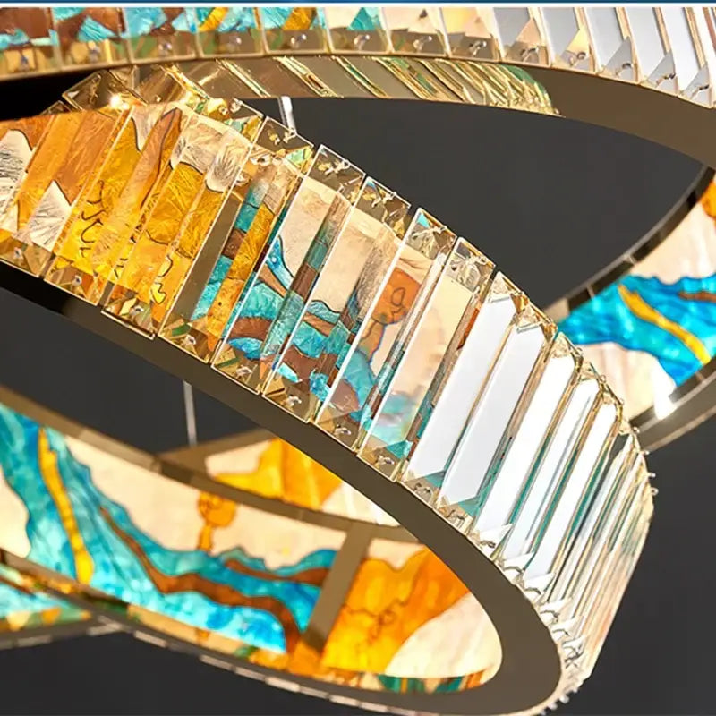 DecorBites crystal chandelier pendant lamp with interlocking rings featuring blue gold amber stained-glass panels