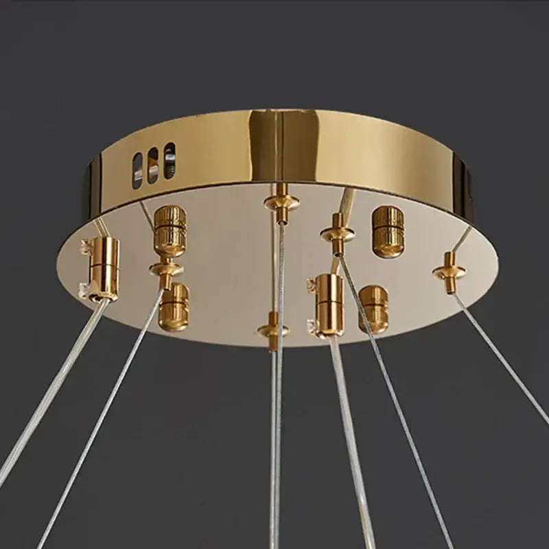 Gold-toned decorbites crystal chandelier pendant lamp with clear glass cords and metallic sockets for elegant home lighting