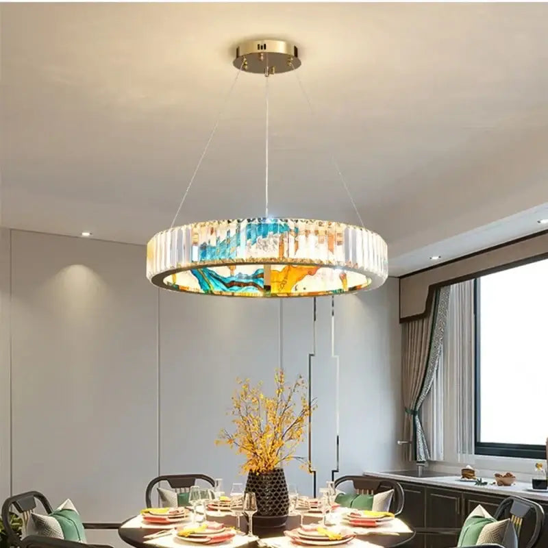 A modern decorbites crystal chandelier pendant lamp with a vibrant blue and yellow stained-glass design and crystal rods