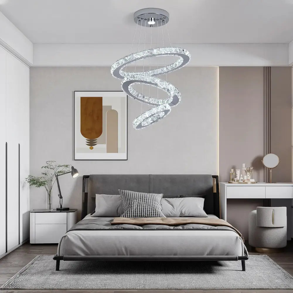 A modern decorbites crystal chandelier pendant lamp with multiple crystal rings and chrome fixture for dining room