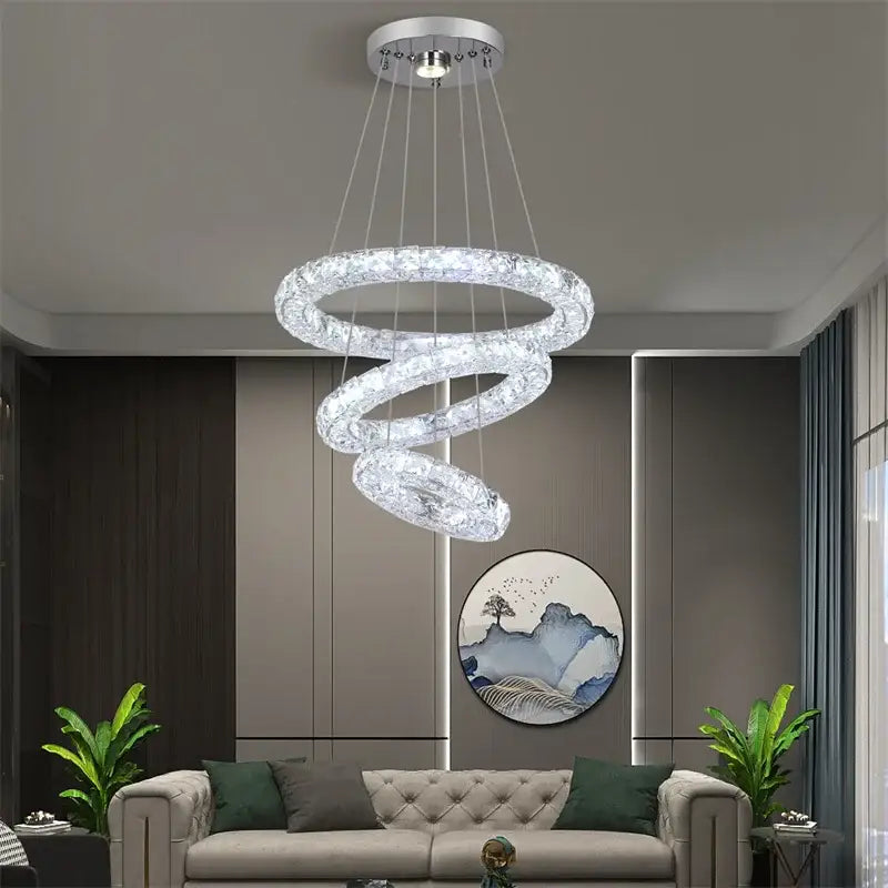 A modern decorbites crystal chandelier pendant lamp with clear crystal accents and silver mount for dining and bedroom