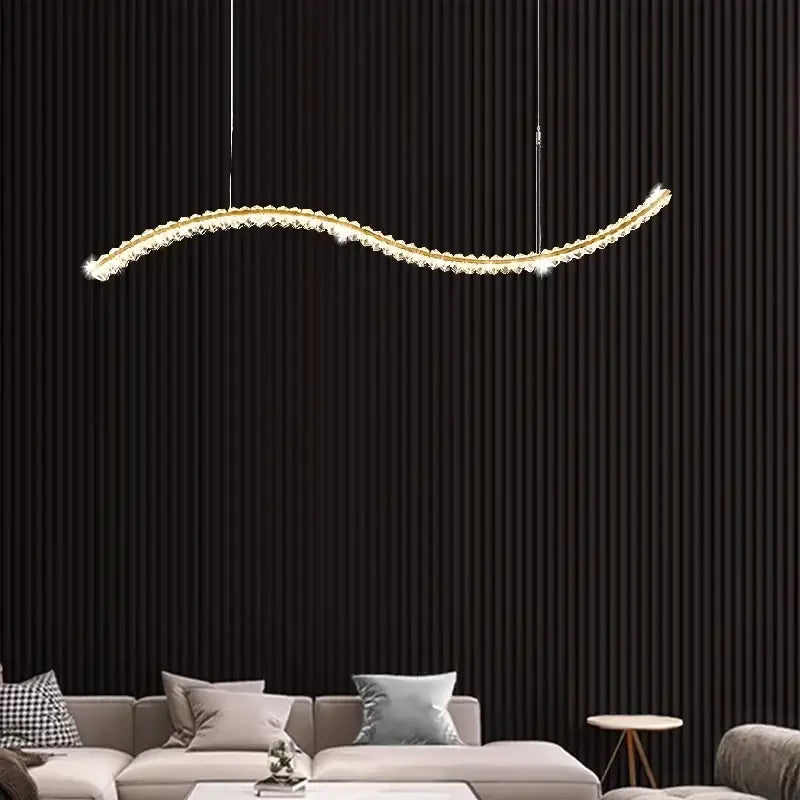 Gold-toned decorbites crystal chandelier pendant lamp with curved design and crystal accents for modern living room