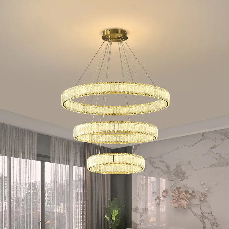 Golden tiered decorbites crystal chandelier with crystal accents ideal for modern living room lighting and home decor