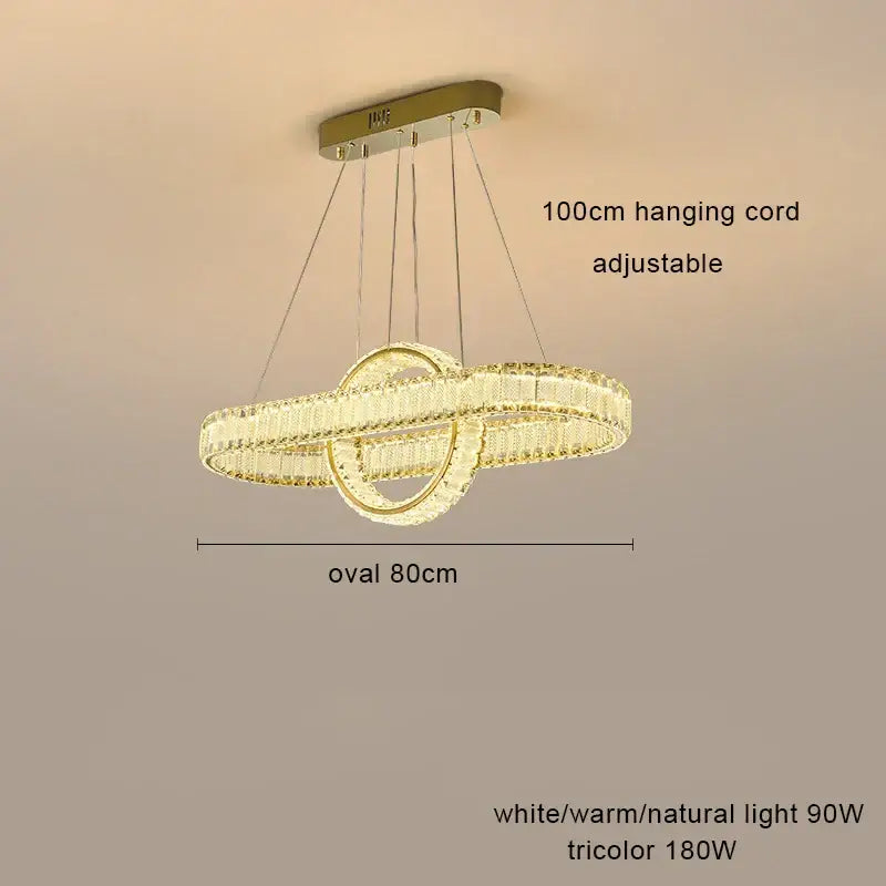 Gold-toned decorbites crystal chandelier with two interlocking oval rings and adjustable 100cm hanging cord for modern living rooms