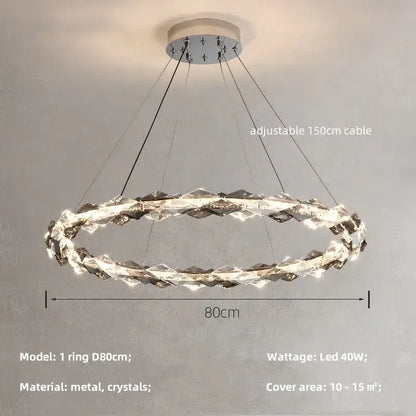 A modern decorbites crystal chandelier pendant light with a metallic base and interlocking crystal rings in chrome