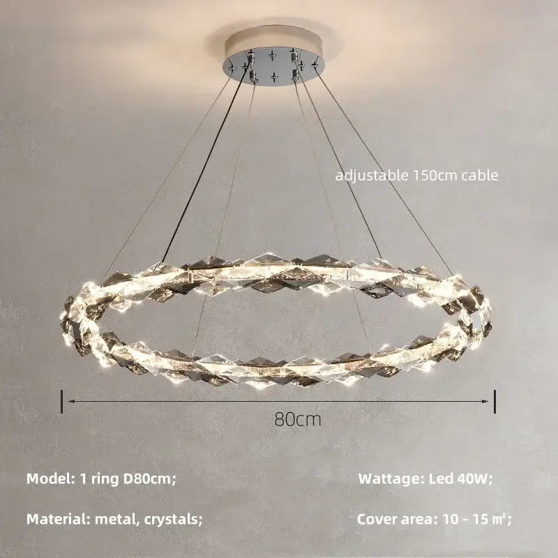 A modern decorbites crystal chandelier pendant light with a metallic base and interlocking crystal rings in chrome