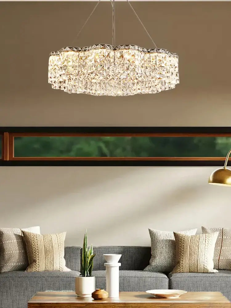 A sparkling circular decorbites crystal chandelier pendant light with faceted design hangs as an elegant lamp fixture