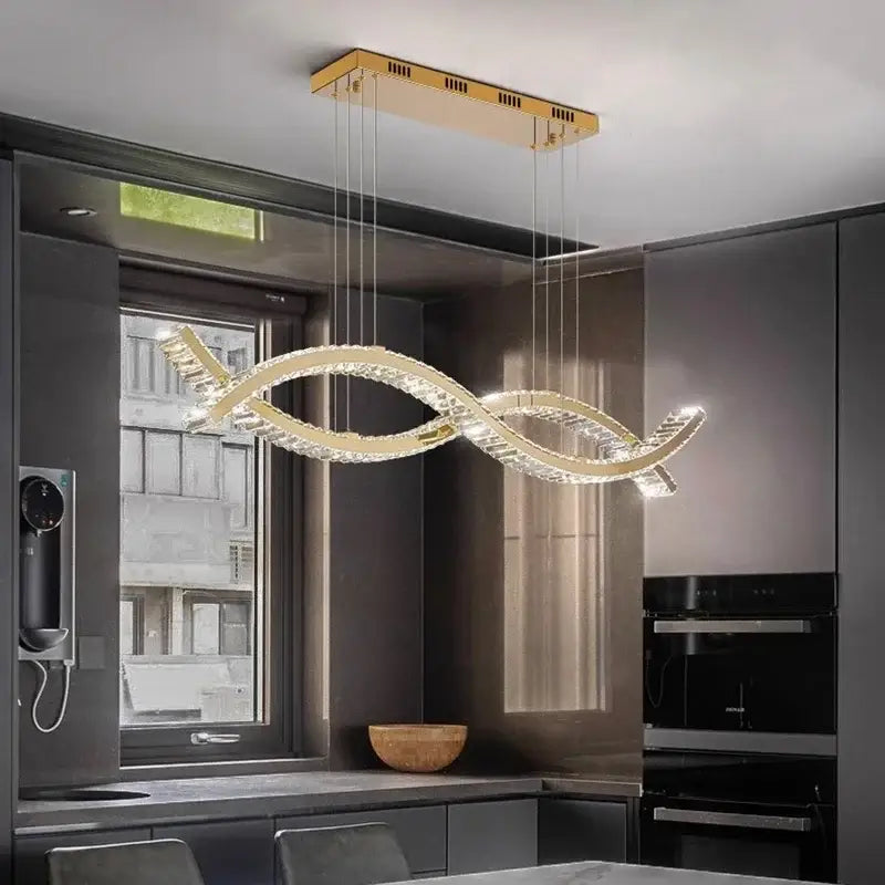 A modern gold-toned decorbites crystal chandelier pendant light with sleek intertwined design for living and dining room
