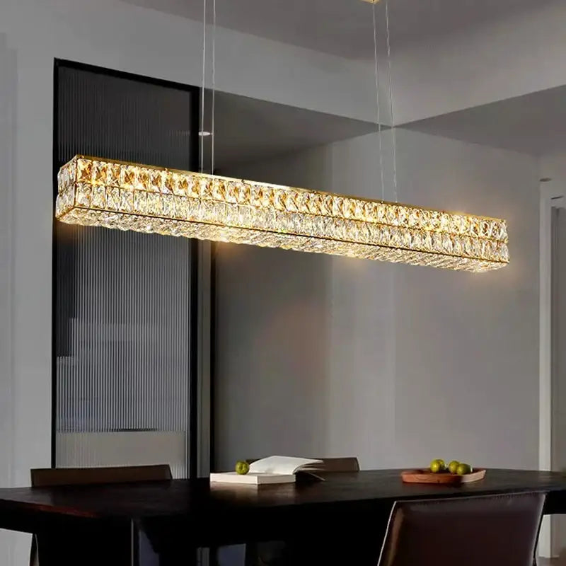 A decorbites crystal chandelier pendant light with a gold-toned frame and clear crystals for living and dining rooms