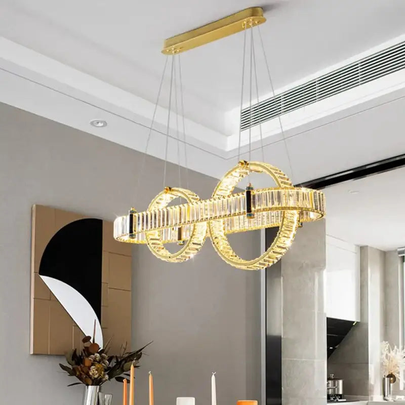 Gold-toned decorbites crystal chandelier pendant light with interlocking circles and crystal accents for living and dining rooms