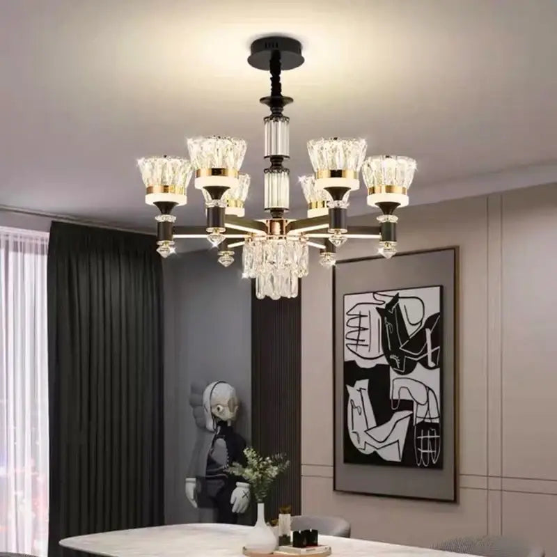 A modern decorbites crystal chandelier pendant light with black and gold metal frame and clear crystal accents for luxury decor