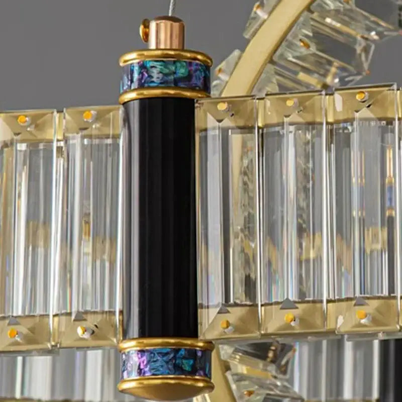 Black cylindrical decorbites crystal chandelier pendant light with gold accents and iridescent blue-green inlay for living room