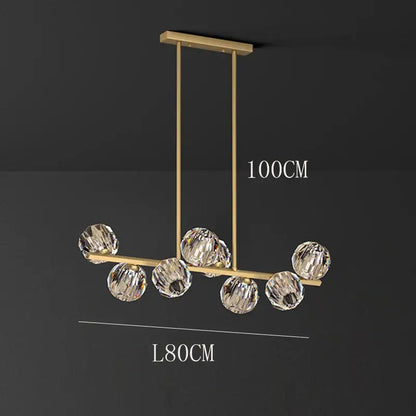 Gold-toned DecorBites crystal chandelier pendant light with seven faceted crystal spheres for living and dining rooms