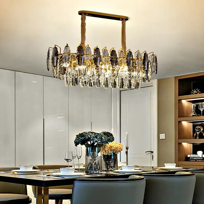 A decorbites crystal chandelier pendant light with gold-toned frame and cascading clear and dark crystal droplets for living room