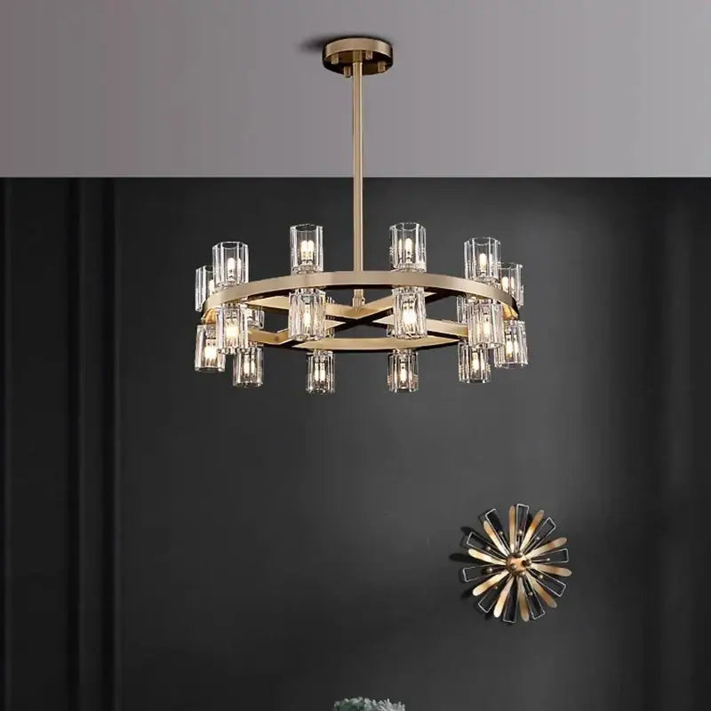 Gold-toned decorbites crystal chandelier pendant light with clear glass candle-style shades in circular modern design