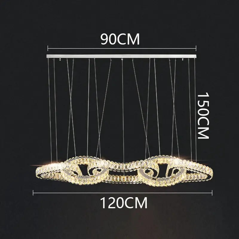 DecorBites crystal chandelier pendant light with silver frame and cascading crystals emitting warm golden light