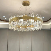 A modern gold-toned decorbites crystal chandelier pendant light with cascading crystal droplets for luxury spaces