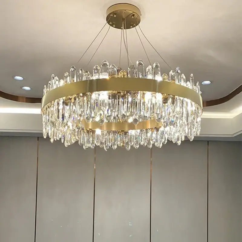 A modern gold-toned decorbites crystal chandelier pendant light with cascading crystal droplets for luxury spaces