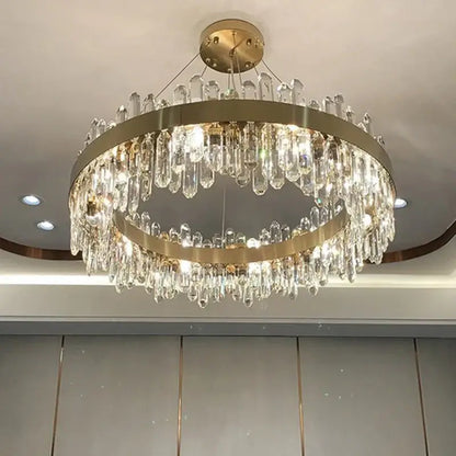 A modern decorbites crystal chandelier pendant light with gold metal rings and clear crystal droplets for luxury rooms