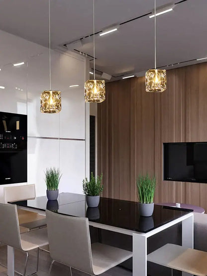 Three decorbites crystal chandelier pendant lights with faceted golden glass shades for modern indoor dining lighting