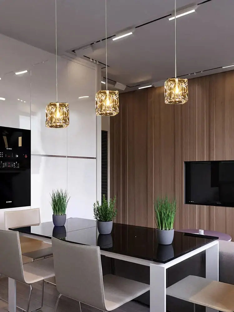 Three decorbites crystal chandelier pendant lights with faceted golden glass shades for modern indoor dining lighting