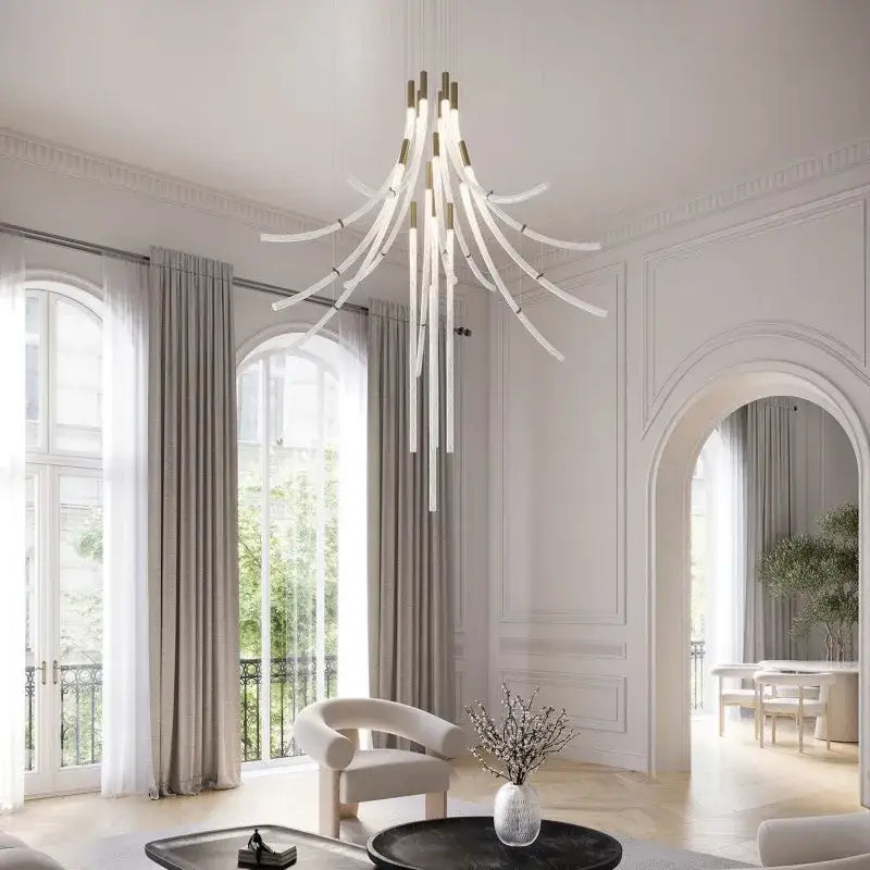 A modern decorbites crystal chandelier pendant light with slender white arms and gold accents for stairs and dining bar