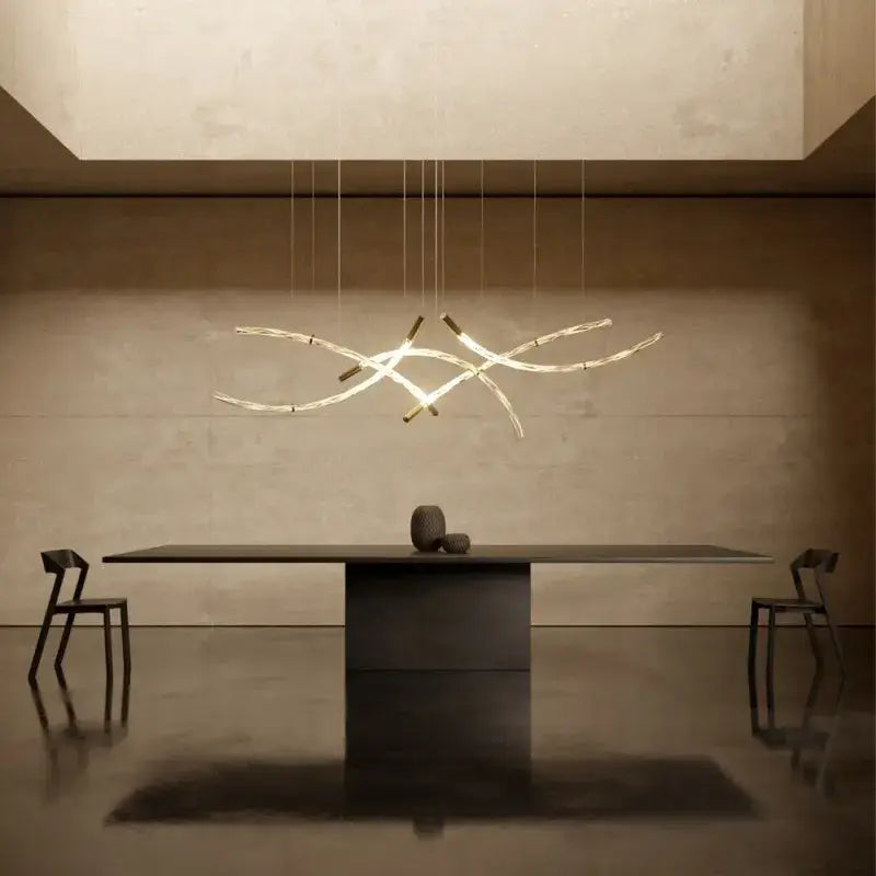 Modern minimalist DecorBites crystal chandelier pendant light with slender glass and metal arms emitting warm glow