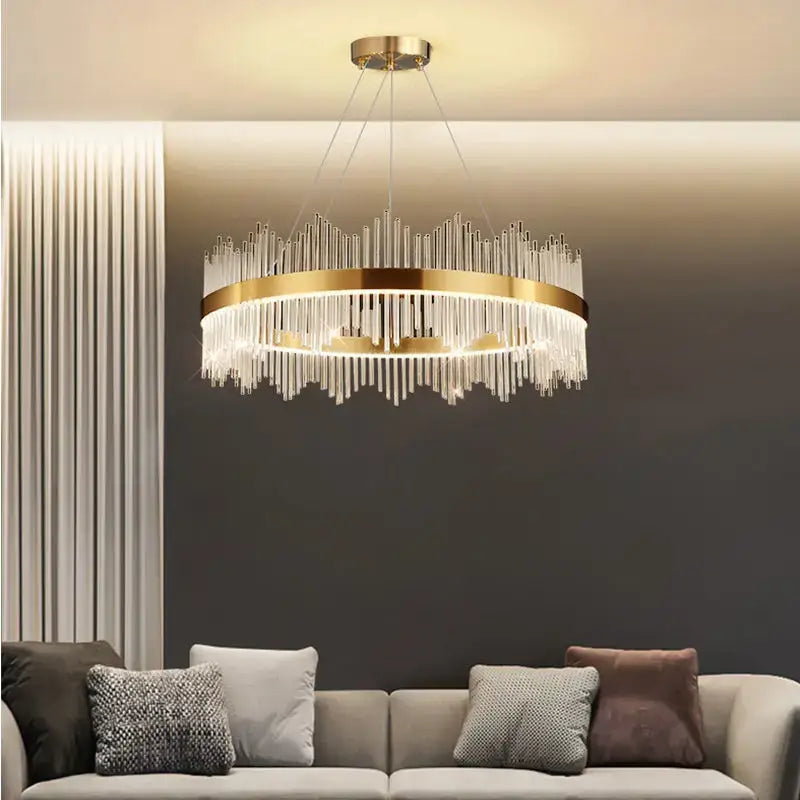 A modern gold-toned metal frame pendant light with cascading clear glass rods from decorbites crystal chandelier collection