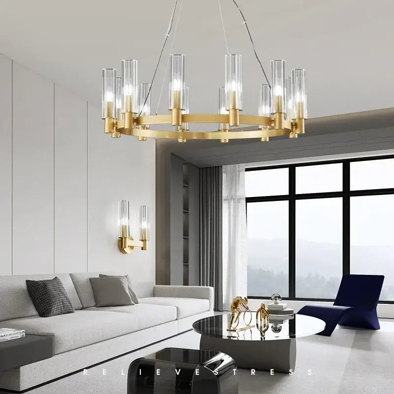 Gold-toned decorbites crystal chandelier pendant lights featuring clear glass cylindrical shades and modern circular design