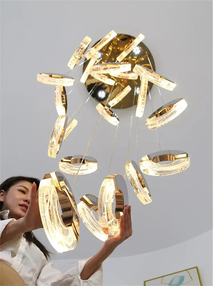 Golden decorbites crystal chandelier pendant light with circular translucent acrylic rings and brass fixture for various spaces